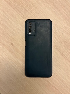 Picture of the back of a black mobile phone with a case